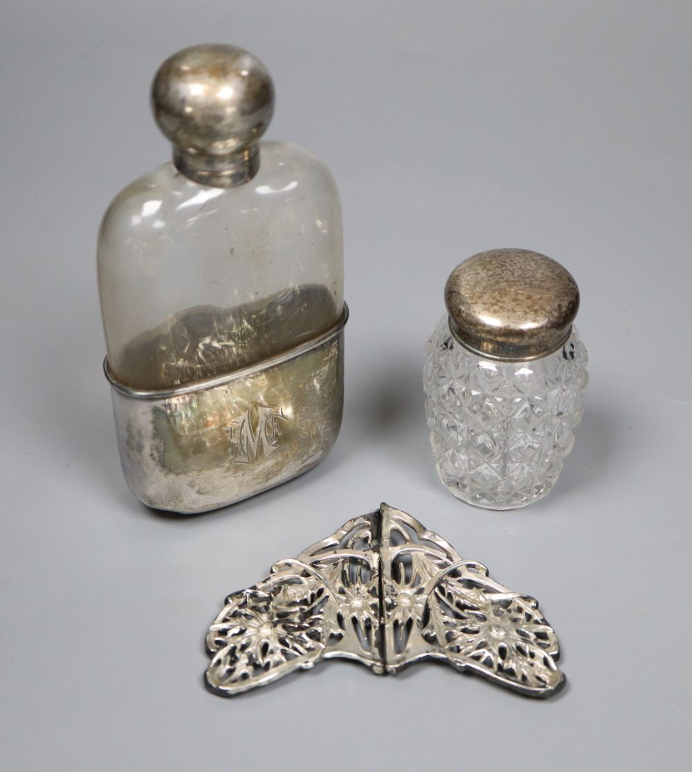 A late Victorian silver mounted glass hip flask, Sheffield, 1890, 14.3cm, an Edwardian silver belt buckle and mounted toilet glass.